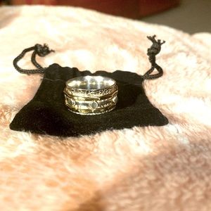 Sterling Silver with 2 gold spinner rings and 1 silver spinner in middle.